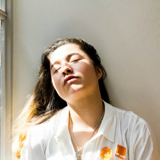 woman standing near window during daytime